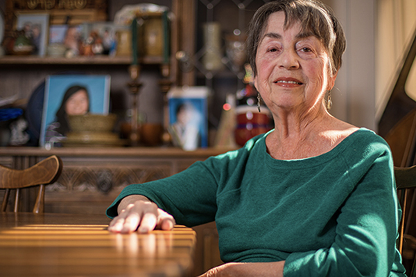 Older woman at home, looking confidently at the camera.