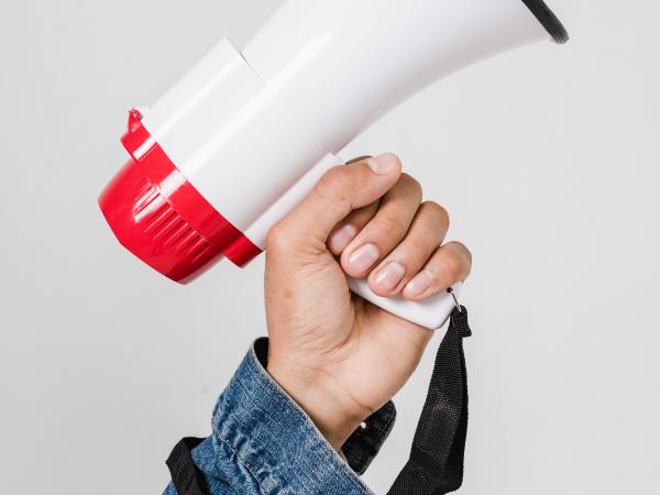 An arm holding a megaphone