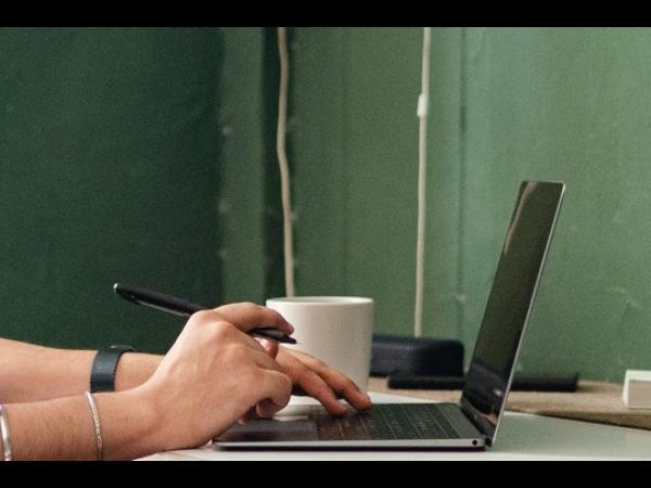 close-up of person's hands typing on a laptop